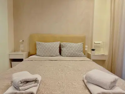 a bedroom with a bed with two towels on it at Elegant apartment in Kolonaki in Athens
