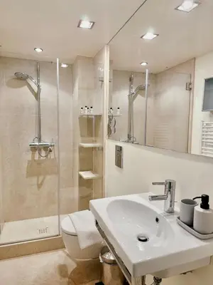 a bathroom with a sink and a shower and a toilet at Elegant apartment in Kolonaki in Athens
