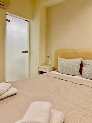 a bedroom with a large bed with a glass door at Elegant apartment in Kolonaki in Athens