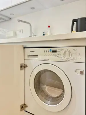 a washing machine in a kitchen with a sink at Elegant apartment in Kolonaki in Athens