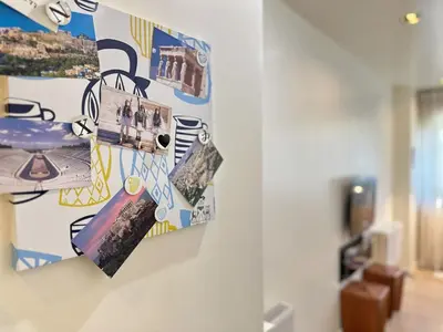 a wall with collaged pictures on it at Elegant apartment in Kolonaki in Athens