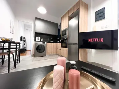 a kitchen with a table with two pink candles at Eva's House - 2 Bedroom Apartment in Athens