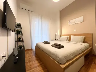a bedroom with a bed with towels on it at Eva's House - 2 Bedroom Apartment in Athens