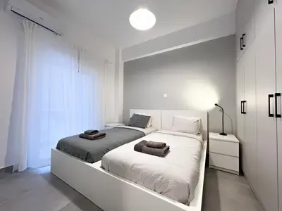 two beds sitting next to each other in a bedroom at Eva's House - 2 Bedroom Apartment in Athens