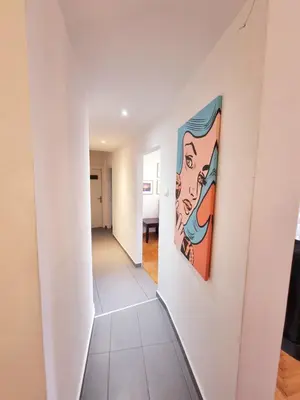a staircase in a house with a painting on the wall at In the Heart of the Center in Athens