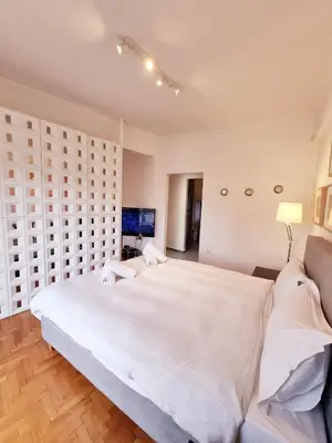 a large white bedroom with a large white bed at In the Heart of the Center in Athens