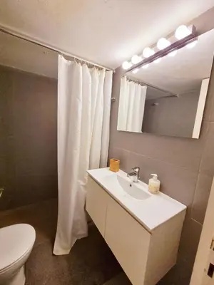 a bathroom with a sink and a toilet and a mirror at In the Heart of the Center in Athens