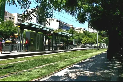 a bus stop on the side of a city street at In the Heart of the Center in Athens