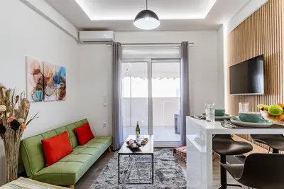 a living room with a green couch and a table at Bright Apartment in Athens City Center 2 Bedrooms with Terrace in Athens