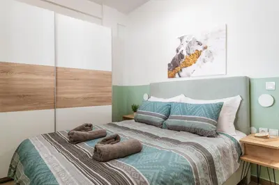 a bedroom with a bed with two towels on it at Bright Apartment in Athens City Center 2 Bedrooms with Terrace in Athens