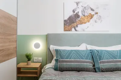 a bedroom with a bed with a blue headboard at Bright Apartment in Athens City Center 2 Bedrooms with Terrace in Athens