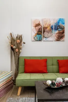 a living room with a green couch and a table at Bright Apartment in Athens City Center 2 Bedrooms with Terrace in Athens