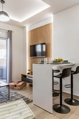 a living room with a bar and a tv at Bright Apartment in Athens City Center 2 Bedrooms with Terrace in Athens