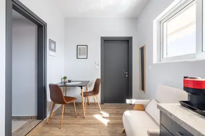 a living room with a table and a couch at Glyfada Center Seaview Two Bedrooms in Athens