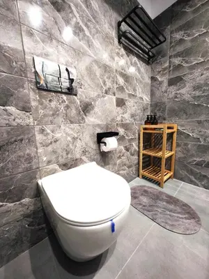 a bathroom with a toilet and a stone wall at Glyfada Center Seaview Two Bedrooms in Athens