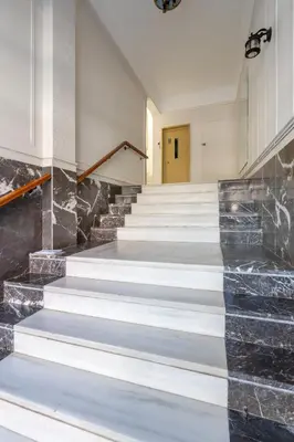 a lobby with stairs with a yellow door at Glyfada Center Seaview Two Bedrooms in Athens