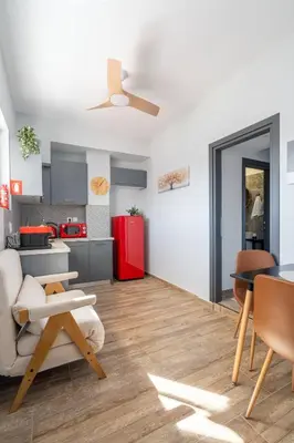 a living room with a table and a kitchen at Glyfada Center Seaview Two Bedrooms in Athens