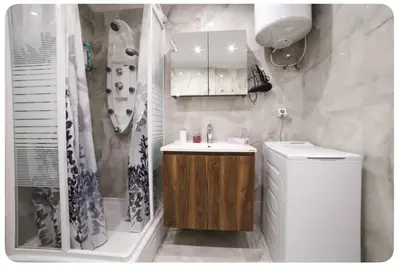a bathroom with a sink and a toilet and a shower at Home4U apt2, just 8Km from airport in Markopoulo