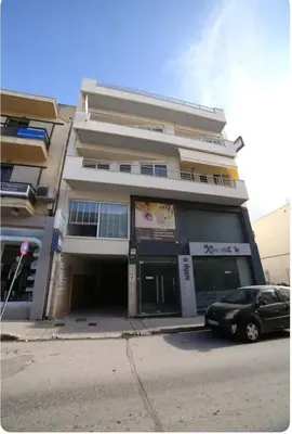 a building with a car parked in front of it at Home4U apt2, just 8Km from airport in Markopoulo