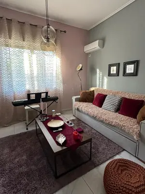 a living room with a couch and a table at Melody Apartment in Athens
