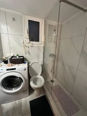 a bathroom with a toilet and a washing machine at Melody Apartment in Athens