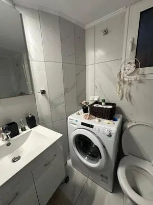 a bathroom with a washing machine and a toilet at Melody Apartment in Athens