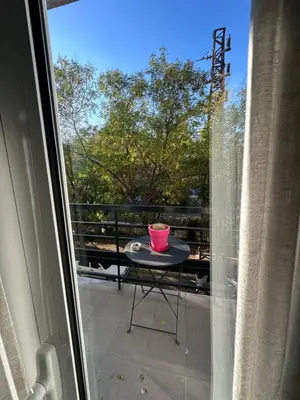 a balcony with a table with a pink bowl on it at Melody Apartment in Athens