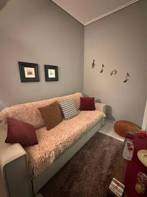 a living room with a couch with pillows on it at Melody Apartment in Athens