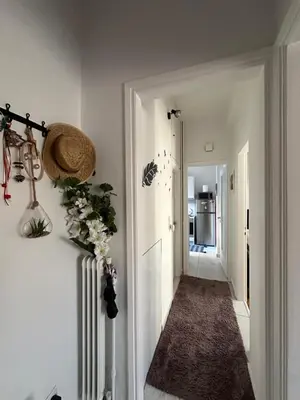 a hallway of a home with white walls at Melody Apartment in Athens