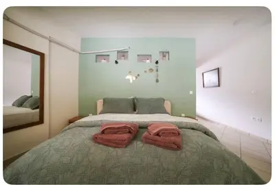a bedroom with a bed with two towels on it at Home4U apt1, just 8Km from airport in Markopoulo