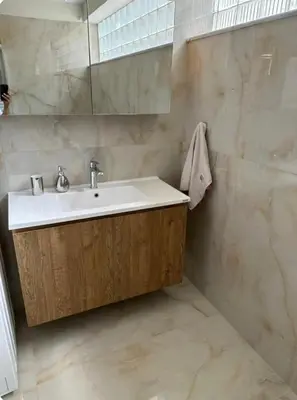 a bathroom with a sink and a mirror at Home4U apt1, just 8Km from airport in Markopoulo