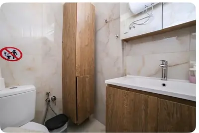 a bathroom with a white sink and a toilet at Home4U apt1, just 8Km from airport in Markopoulo