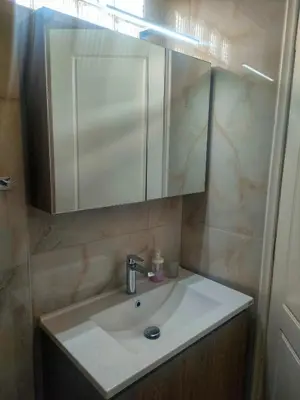 a bathroom with a sink and a mirror at Home4U apt1, just 8Km from airport in Markopoulo