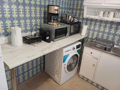 a kitchen with a washing machine and a microwave at Acropolis view in Lycabettus in Athens