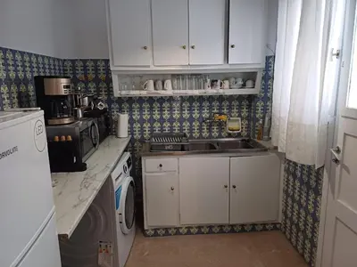a small kitchen with a sink and a stove at Acropolis view in Lycabettus in Athens