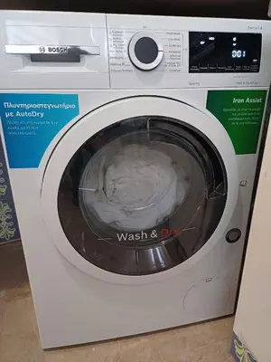 a washing machine with a washer in a room at Acropolis view in Lycabettus in Athens