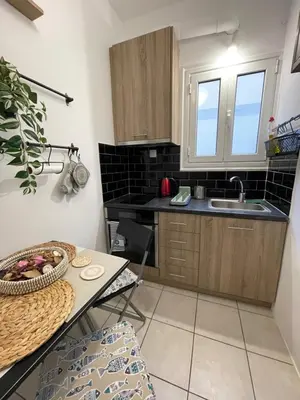 a small kitchen with a table and a sink at Modern Studio in Palaio Faliro in Athens