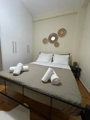 a bedroom with a bed with two pillows on it at Modern Studio in Palaio Faliro in Athens