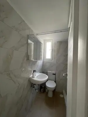 a white bathroom with a sink and a toilet at Modern Studio in Palaio Faliro in Athens