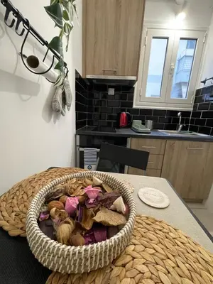 a basket of stuffed animals sitting on a table in a kitchen at Modern Studio in Palaio Faliro in Athens