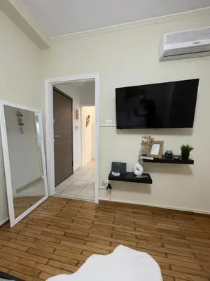 a living room with a flat screen tv on the wall at Modern Studio in Palaio Faliro in Athens