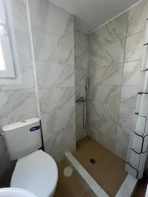 a bathroom with a toilet and a shower at Modern Studio in Palaio Faliro in Athens