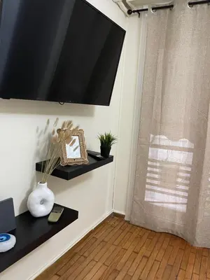a flat screen tv hanging on a wall at Modern Studio in Palaio Faliro in Athens
