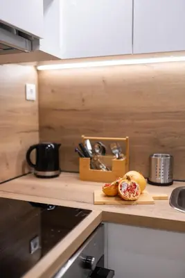 a kitchen counter with a cutting board with a sandwich on it at Central 2 Bdrm Aprt In Koukaki! in Athens