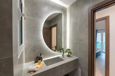 a bathroom with a sink and a mirror at Central 2 Bdrm Aprt In Koukaki! in Athens