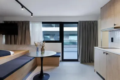 a kitchen and living room with a table in a room at MoRe by Zoia Living in Athens