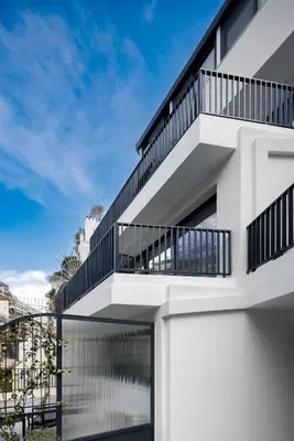 a white building with black balconies on it at MoRe by Zoia Living in Athens