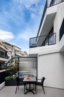 a balcony with a table and chairs on a building at MoRe by Zoia Living in Athens