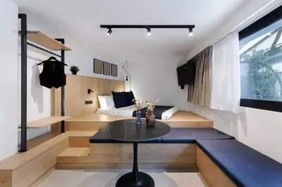 a living room with a table and a couch at MoRe by Zoia Living in Athens