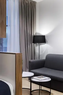 a living room with a couch and a table at MoRe by Zoia Living in Athens